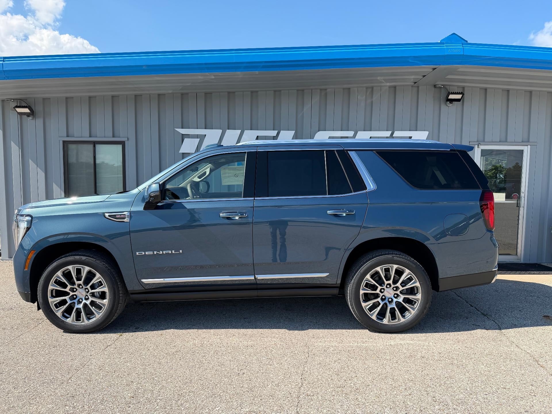 2026 GMC Yukon Denali in Downpour Metallic — front three-quarter view