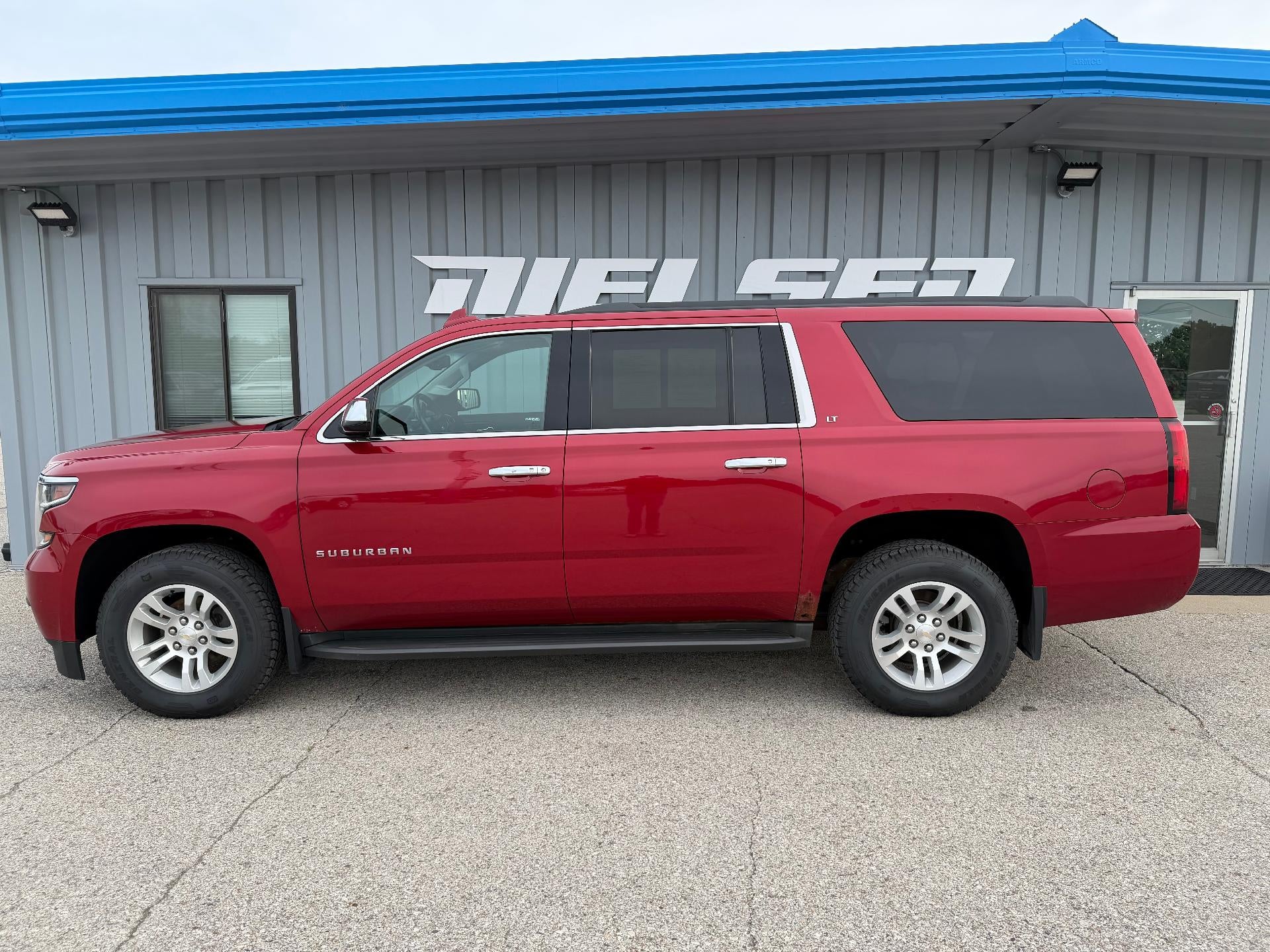 2015 Chevrolet Suburban LT in Crystal Red Tintcoat — front three-quarter view