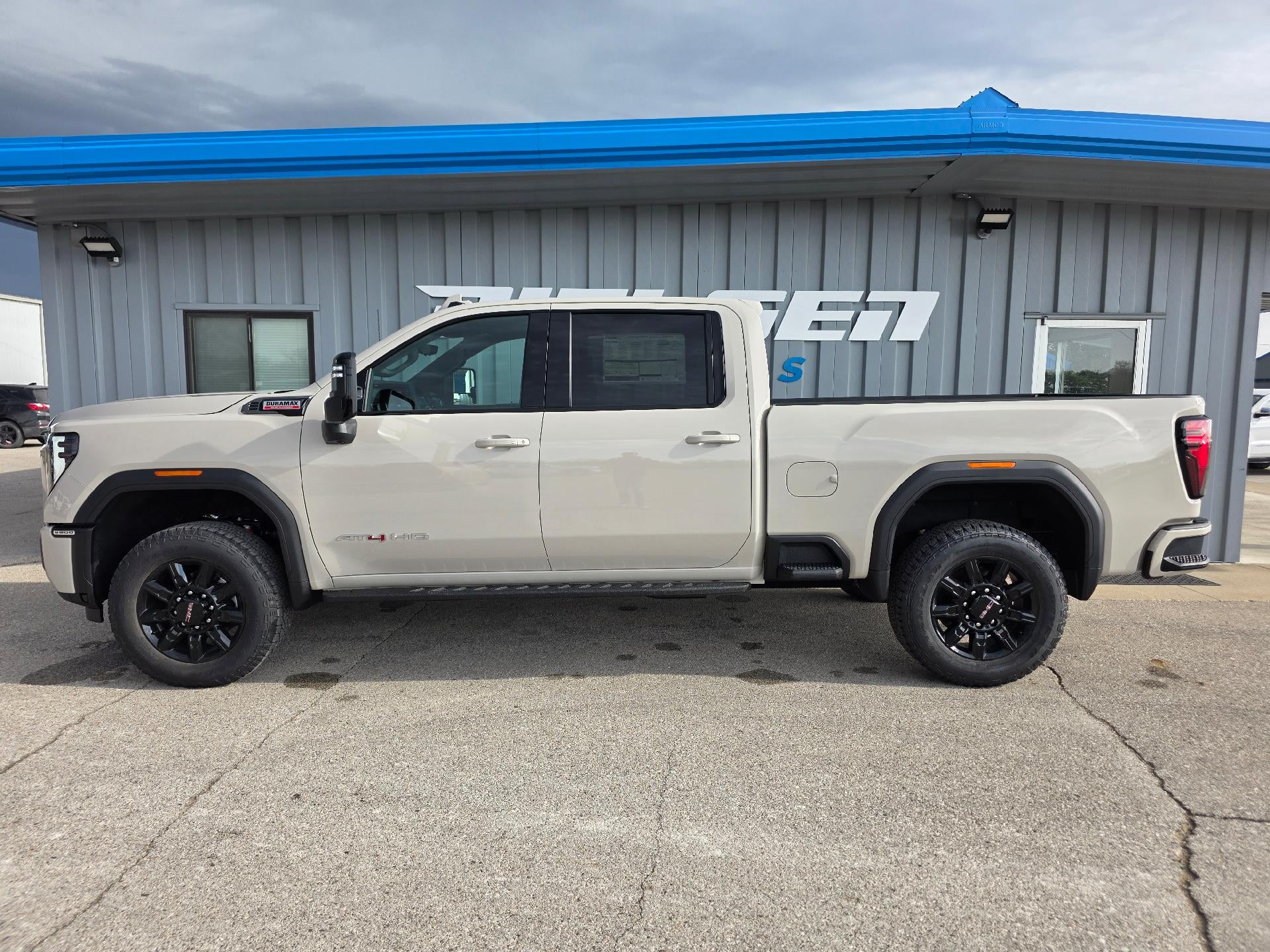 2026 GMC Sierra 2500 HD AT4 in Coastal Dune — front three-quarter view