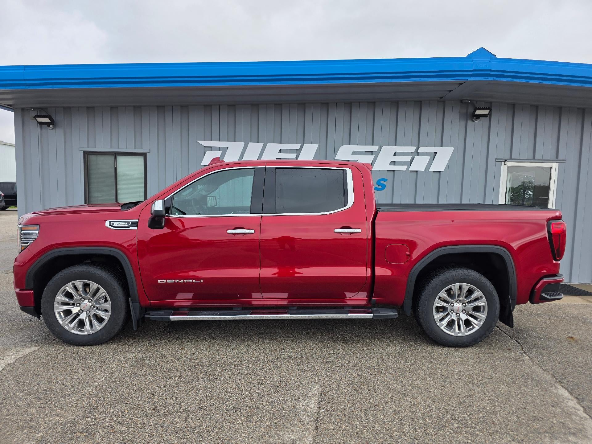 2024 GMC Sierra 1500 Denali in Volcanic Red Tintcoat — front three-quarter view